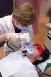 Figure 2 A patient is screened for oral cancer with the the VELscope Mucosal Examination System; the band of blue light identifies changes in the mucosa that cannot be seen in normal light conditions.