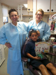 Figure 5 Luz Cubillos, DDS, and Michelle Tellez with a patient at the mobile dental unit.
