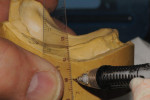 To identify the occlusion center, draw a line 90° to the occlusal table on the side of the cast.
