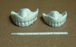 Figure 13. A denture printed with greater
resolution but less accuracy does not ensure success. Two printed dentures are shown having identical proportions, yet the one on
the right is inaccurate.