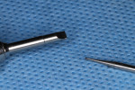 Figure 8 To remove stripped or damaged screws, slot-head driver is used in conjunction with appropriately sized carbide round bur (1/2 round shown here). In some instances, surgical length burs will be needed.