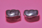 (Left) Mandibular primary second molar crown form as supplied from the manufacturer.
(Right) Same size crown form trimmed, contoured, crimped, finished, and polished.