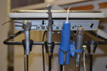 The Aquasil Ultra Cordless Tissue Managing Impression System. The parts of the system include the digit power Dispenser, which contains the digit power impression cartridge and is capped with an ultrafine intraoral tip (left), a regulator, and an adaptor (right) allowing the system to fit into a tool holder in the dental unit.