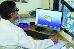 A technician at Noel Laboratories designs a case using CAD software.