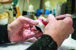 Fig 1. A Dent-Estherium technician works on a prosthesis that features the Lock 'n' Release bar.