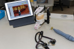 Fig 1. A case is mounted on an articulator next
to a tablet with case photos from the clinician.
