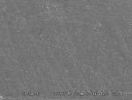 Fig 4. SEM micrograph of a resin composite material after surface treatment with a 15-µm fine diamond bur followed by a diamond-impregnated micropolishing point (Flame Point Pre-polisher and Shine) (R2).