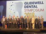 Jim Glidewell, CDT, center, poses with the main-stage and workshop speakers at the Glidewell Dental Symposium in National Harbor, Maryland.