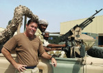 Figure 1  Col. William J. Dunn, DDS, USAF, Commander, Detachment 1, talks with local guards at his post in the Middle East.