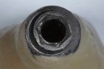 Fig. 3. Hex sheared off of abutment base. The appearance of the abutment base suggests use of airborne-particle abrasion, abutment connection damage, and excessive ceramic material.