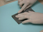 Figure 1  A dental assistant folds the dam, creating a crease in the middle.
